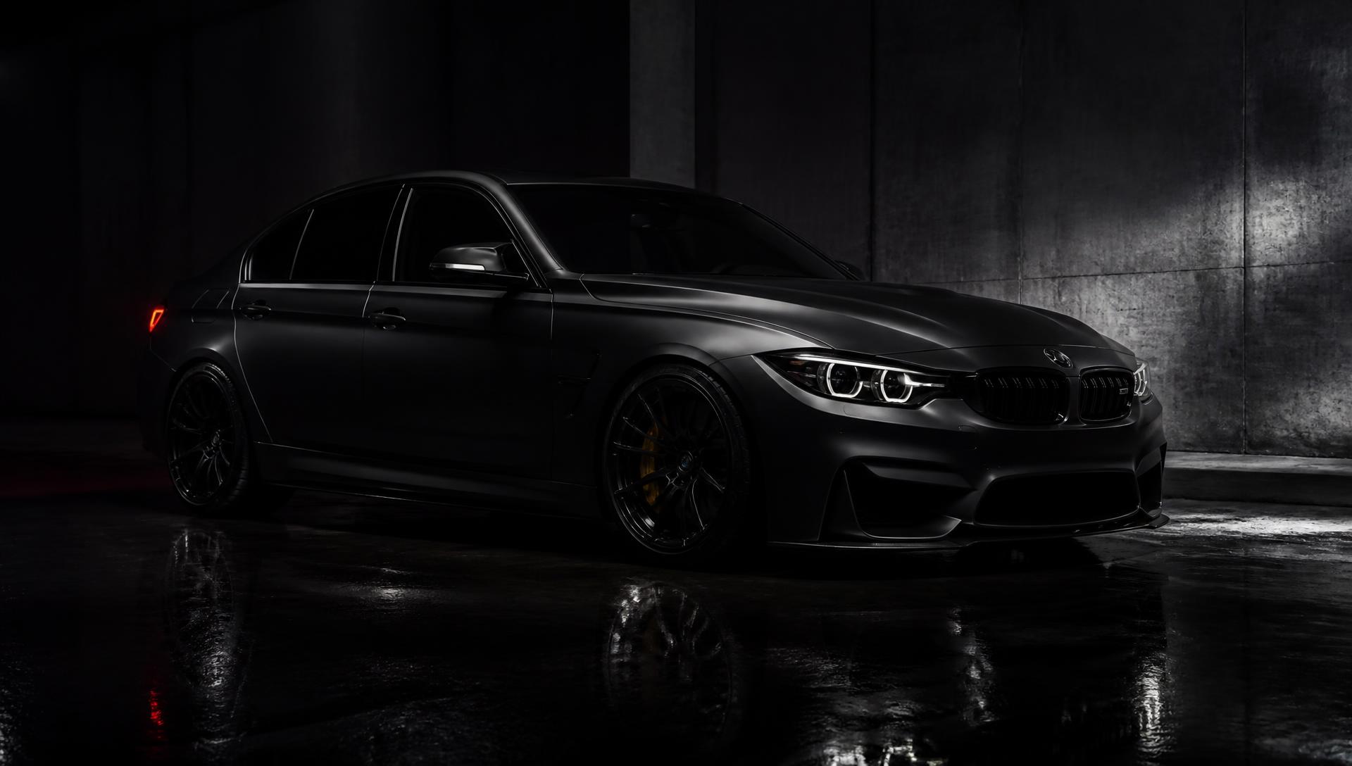 Blacked-out performance sedan with premium window tint in a dark studio